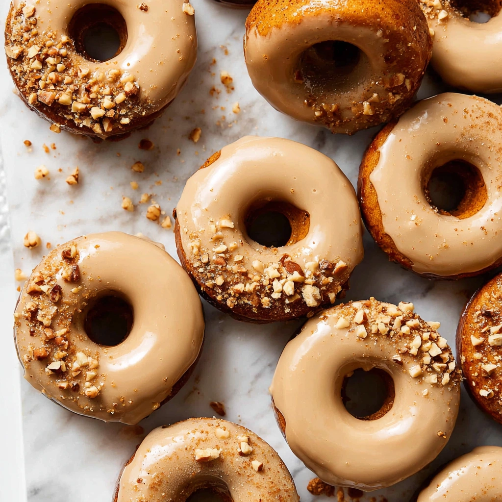 A batch of quick and easy baked pumpkin donuts, displayed on a wire rack to cool.